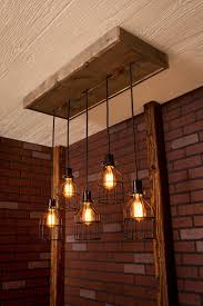 Discover industrial dining room ideas and inspiration for your decor, layout, furniture and storage. Industrial Lighting Industrial Chandelier By Bornagainwoodworks Dining Room Industrial Rustic Lighting Cage Light Chandelier