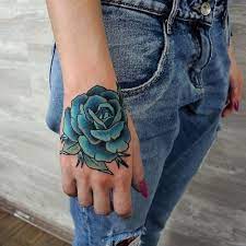 Blue Rose Tattoo On Hand For Girls Rose Hand Tattoo Blue Rose Tattoos Traditional Rose Tattoos