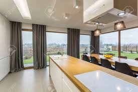 They also work wonderfully as dining room valances or anywhere else you might need a hint of extravagance. Wooden Kitchen Counter And Dining Room With Big Windows And Curtains Stock Photo Picture And Royalty Free Image Image 78950305