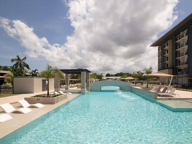 an expansive pool with a poolside bar at Novotel Darwin Airport Hotel