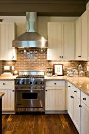 Farmhouse Kitchen With Brick Backsplash And Wood Floors Brick Backsplash Kitchen Small Country Kitchens Farmhouse Style Kitchen