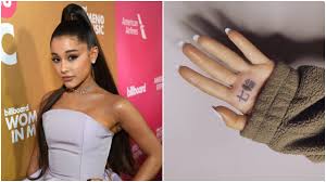 Ariana grande's latest single 7 rings has achieved monumental success since its release earlier this month, smashing streaming records and to celebrate, the star decided to add a tattoo to her growing collection, having the phrase 7 rings tattooed in japanese characters on the palm of her hand. Ariana Grande Accidentally Got Bbq Grill Tattooed On Her Hand