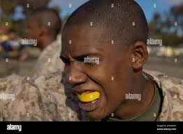 U.S. Marine Corps Recruit Omari Allen with Mike Company, 3rd Recruit  Training Battalion, executes a forward strike during the combat  conditioning course at Marine Corps Recruit Depot San Diego, Jan. 4, 2023.