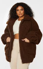 Featuring a camel borg material, a zip up front with pockets and an elasticated hemline. Plus Camel Oversized Borg Pocket Front Coat Prettylittlething Usa