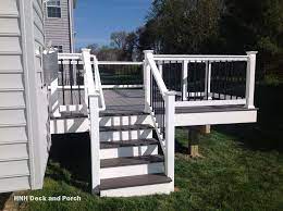 Vinyl Deck Using Wolfbuilding Seaside Collection Pvc Decking With Harbor Grey Flooring White Pvc Posts And Black Square Al Deck Steps Vinyl Deck Deck Colors