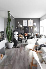 It can channel edgy modern and charming country; Dark Grey Black Wall Living Room Idea With Indoor Plants And Amazing Wall Art Black Walls Living Room Living Room Grey Dark Grey Living Room