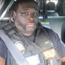 An officer pulls over a man and a woman for driving 20 miles per hour over  the posted speed limit. The officer approaches the car, sees an  affluent-looking late-50s man behind the