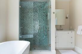 The bathroom are tiled with hex marble tile on the floor and herringbone marble tiles in the shower. Blue Glass Herringbone Shower Tiles Cottage Bathroom