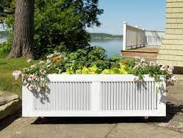 Wooden outdoor planter on wheels. How To Build A Raised Garden Bed From Pallets Hgtv