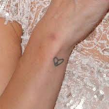 With wars continuing overseas, pacifists and supporters of bringing our troops home may choose to have a peace tattoo placed somewhere visibly (such as an arm, wrist or shoulder) to express their longing to peace. Ashley Roberts Heart Peace Sign Wrist Tattoo Steal Her Style