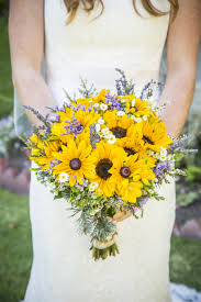 Bouquet Of Yellow And Creme Wildflowers With Lilac Accents Sunflower Wedding Bouquet Sunflower Themed Wedding Sunflowers And Roses