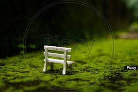 To start, backgrounds are not likely to be in a fixed frame and will need to be equally beautiful when viewed on a large fullscreen, widescreen, or a mobile phone screen. Image Of A Toy Park Chair In A Green Grass Surface With Beautiful Blurry Background Cu783031 Picxy