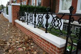 Black Cast Iron Railings On Top Of Red Brick Wall In London Front Garden Front Garden Design Front Garden Brick Columns