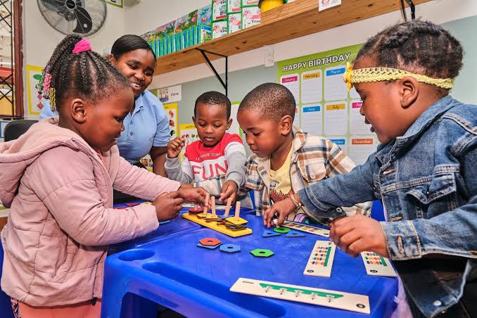 An ECD educator guiding children through developmental play activities, AI generated