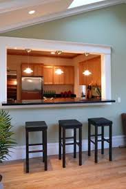 This modern kitchen design has it all—two refrigerators, two sinks, and two islands. Window Decor Between Kitchen And Dining Room Half Wall Kitchen Living Room Kitchen Rustic Kitchen