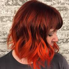 This is a cool hair style where the hair is dyed in light brown and styled with a back brush sweep. Red Hair Tips On Brown Hair Red Hair