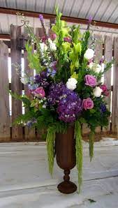 Bells Of Ireland Purple Hydrangea Lavender Roses Ivory Roses With Delphinium And Funeral Flower Arrangements Church Flower Arrangements Flower Arrangements