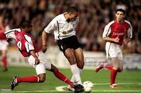 John carew of valencia scores the second and decisive goal during the uefa champions league second phase. Valencia S John Carew Shoots At Goal Under Pressure From Arsenal S Adidas Predator Sports Photography Under Pressure