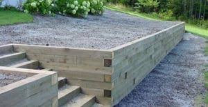 The round interlock provides a beautiful symmetrical view and the wooden boards on top of the gabion wall are both functional and beautiful. Wood Retaining Walls Peachtree City Fayetteville Ga Landscape Innovations