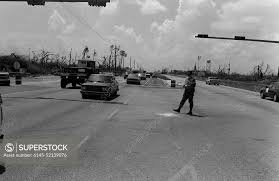 SPC Mike Armstead from the 437th Military Police Company, Fort Belvoir,  Virginia, helps direct traffic after Hurricane Andrew knocked out power to  the area. Base: Homestead Goulds Park State: Florida (FL) Country: United  States Of America (USA ...