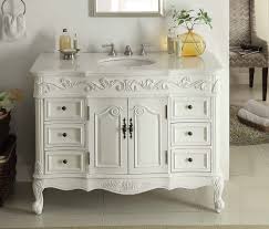 A tall center cabinet divides this long vanity into separate spaces. Adelina 42 Inch Traditional Style Antique White White Bathroom Vanity