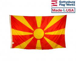 Знаме на северна македонија) depicts a stylized yellow sun on a red field, with eight broadening rays extending from the center to the edge of the field. Flag Of Macedonia