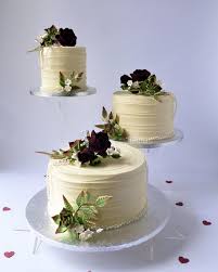 Top tier is triple layer chocolate hazelnut cake with buttercream icing airbrushed purple. Offset Buttercreamed Wedding Cake With Coloured Sugar Roses Blossoms And Succulents Karen S Cakes