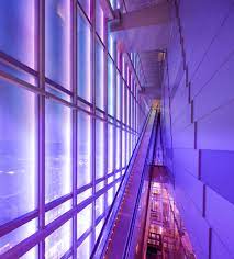 Long Escalator In Orchard Central Singapore Behind Glass Facade Lit By Purple And Pink Neon Lights Photo Facade Lighting Light Architecture Pink Neon Lights