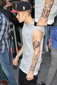 Justin bieber and tattoos go together like.well, like harry styles and tattoos. Justin Bieber S Tattoos A Selena Gomez Look A Like A Crown Jesus Ink And More