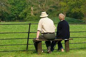 Elderly Pensioners Relaxing Elderly Couple Sitting Together On A Bench In Front Ad Couple Sit Older Couple Photography Stock Images Free Couples Images