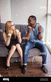 Interracial couple on date view through cafe window - Afro american man  using phone and asian girlfriend facial expression in love - Cheerful mixed  ra Stock Photo - Alamy