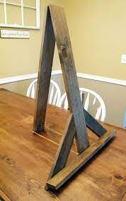 These sturdy, solid wood easels comfortably hold signs up to 10 lbs, and up to 30 x 40 inches, yet quickly fold flat for easy transportation. Rustic Table Top Easel Wood Easel Sign Holder Wedding Sign Holder Wedding Easel Chalkboard Easel Easel Large Tab Wood Easel Diy Table Top Tabletop Easel