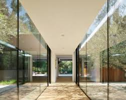 Hallways are sometimes afterthoughts when it comes to lighting and decor: This Serene Family Home Is Connected By Glass Hallways