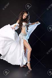 Bellydance. Beautiful Arabic Sexy Belly Dancer In Blowing White Dress  Dancing Isolated On Black Studio Background. Attractive Smiling Turkish  Female Performer Artist. Stock Photo, Picture and Royalty Free Image. Image  68830407.