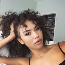 Wavy and curled, dark hair reaching up to neck having thin streaks of yellow and red looks attractive. Best Curly Hair Products Hair Products For Curly Hair Teen Vogue