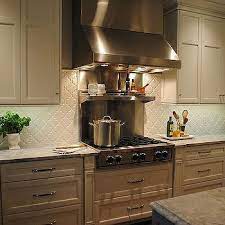 White shaker cabinets painted sherwin williams pearly white accented with nickel cup pull hardware alongside white marble counters with a mission stone tile beveled arabesque tile backsplash filling the range alcove. Beveled Arabesque Tile Glossy White Design Ideas
