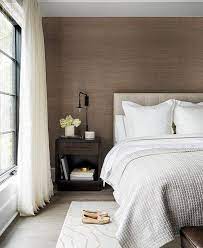 Here, the simple, clean lines of modern design pair perfectly with layered grays, as seen in this room, painted in striking aura ® color stories ® colors: Packed With Style This Modern Gray And Brown Bedroom Features An Accent Wall Covered In Brown Grassc White And Brown Bedroom Brown Bedroom Walls Brown Bedroom