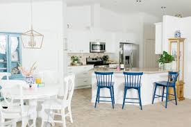 a bright white kitchen with mema's blue