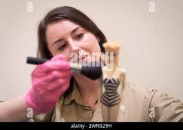 Exhibition curator Danielle Thom holds a rare first edition Barbie doll  ahead of announcing the dolls,