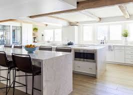 The wood used on this one, however, has a bit more red undertone, giving it a slight purplish tinge, which helps the white cabinets stand out just as well as the wengue floors. 50 Best White Kitchen Design Ideas