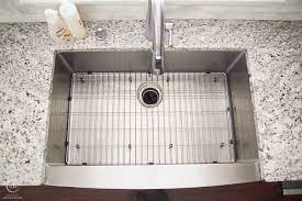 Cookie sheets, skillets with elongated handles. How To Clean A Kitchen Sink Grid Simply Designing With Ashley
