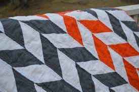 I think my favorite part is the pop of orange. An Orange And Grey Herringbone Quilt Newlywoodwards