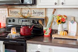 This black and white kitchen has a hardwood floor. Colorful Rustic Farmhouse Fall Decor Ideas The American Patriette