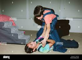 Brother and sister wrestling hi-res stock photography and images - Alamy