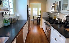 So for instance, if you go for dark cabinets, you can consider offsetting the effect by going for. White And Black Galley Kitchen Transitional Kitchen Jeff Lewis Design