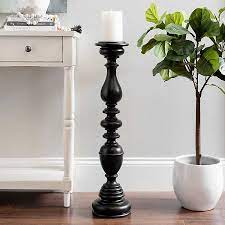 One measures 2′ 5″ tall, the other is 2′ 3″ tall. Black Floor Candle Holder 32 In Kirklands