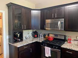 A kitchen with light gray. What Color Should I Paint My Kitchen Cabinets Textbook Painting