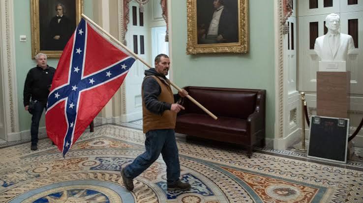 Confederate flag-wielding father, son found guilty in Capitol riot