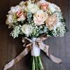 At the bottom of the bouquet's stem, fold a small square of finishing ribbon in half to make a triangle and then hot glue the middle of the triangle to the tip of the stem. 1