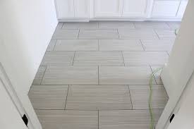 In Two Of The Bathrooms We Went With A Neutral Gray Color On The Floors In Large 12 X 24 Tiles 12x24 Tile 12x24 Tile Patterns Tile Floor